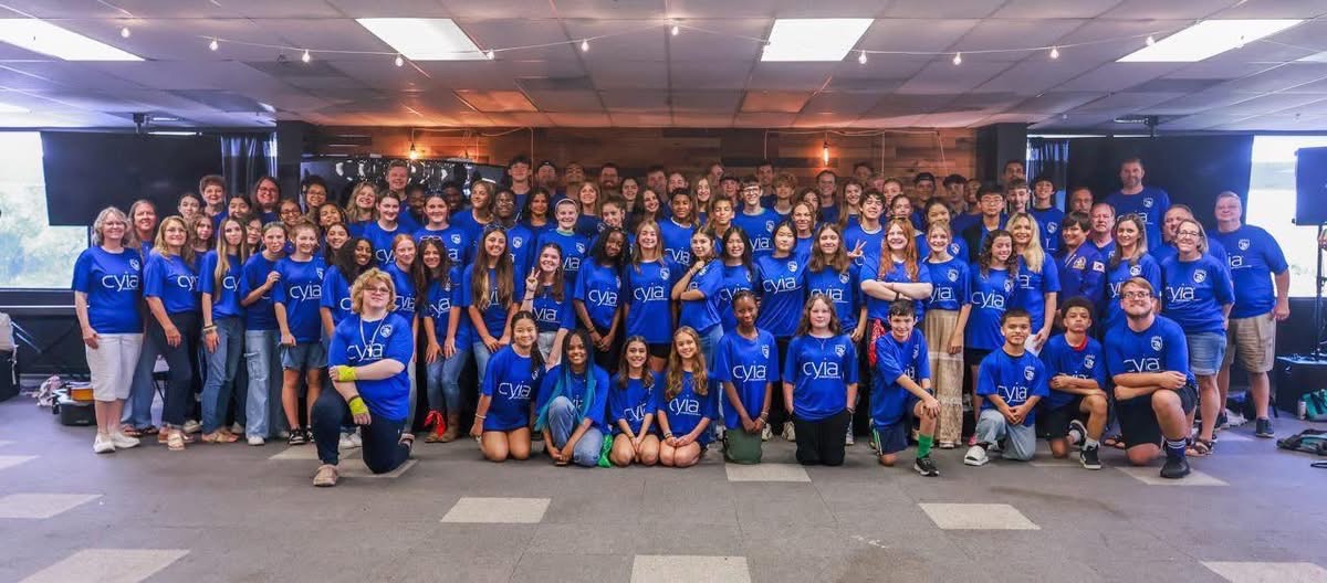 The 2026 Christian Youth in Action summer team gathered together in matching blue CYIA shirts